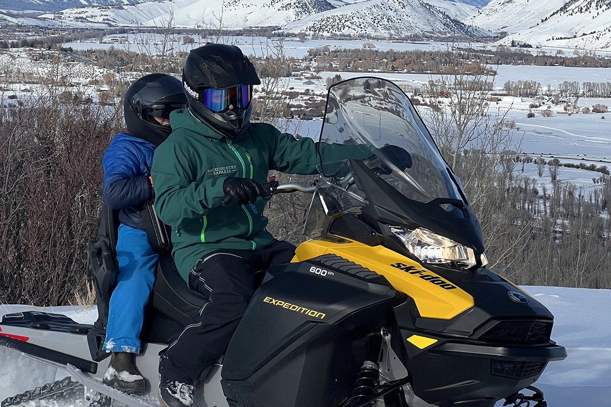 Backcountry Safaris Snowmobile Guide Riding with Child on Jackson, WY Snowmobile Tour