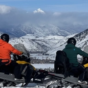 Backcountry Safaris Snowmobile Guide and Guest View the Grand Teton During Tour